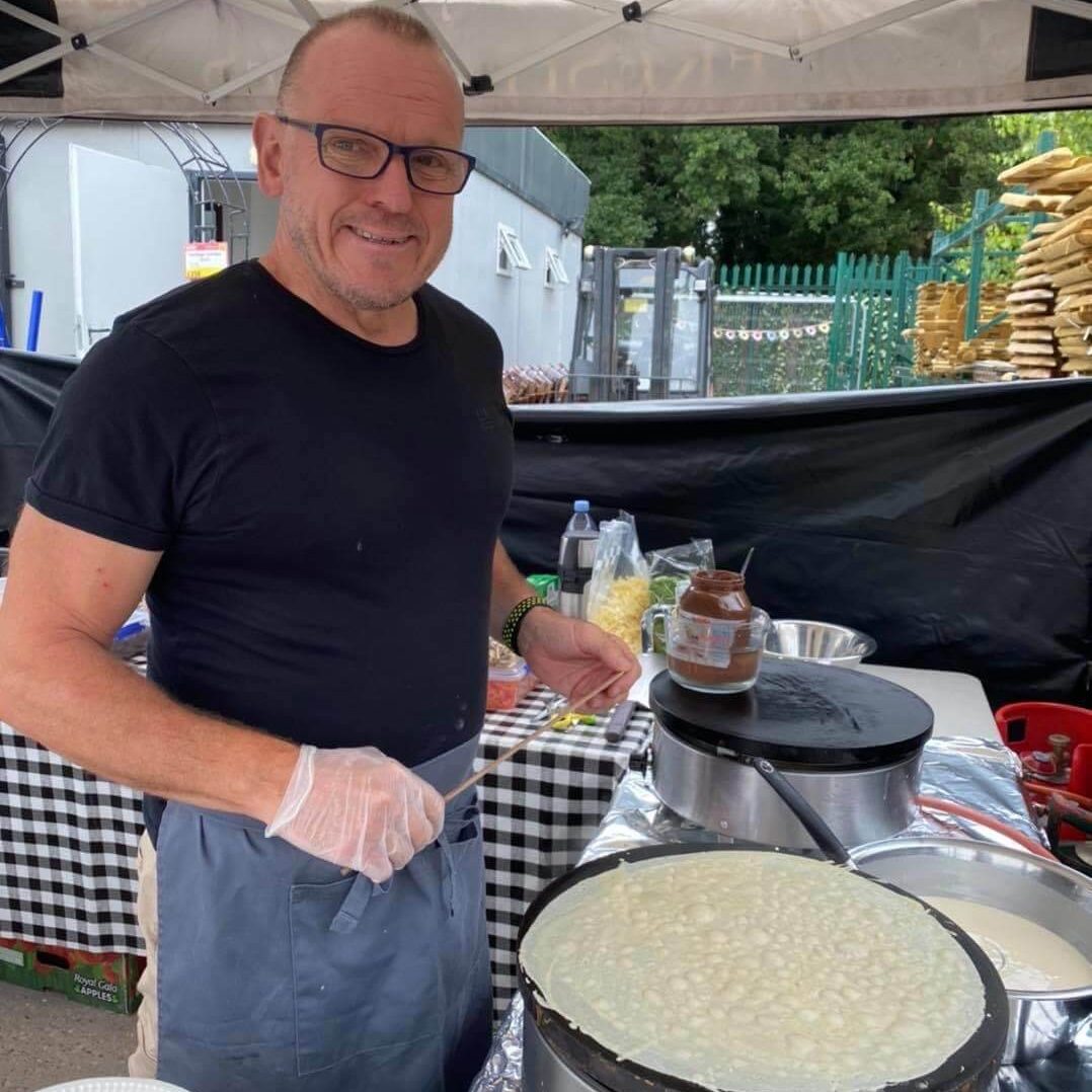 Mark Posing for the camera while making a crepe